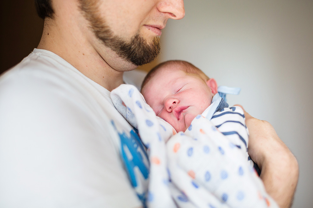 newborn sound asleep with daddy