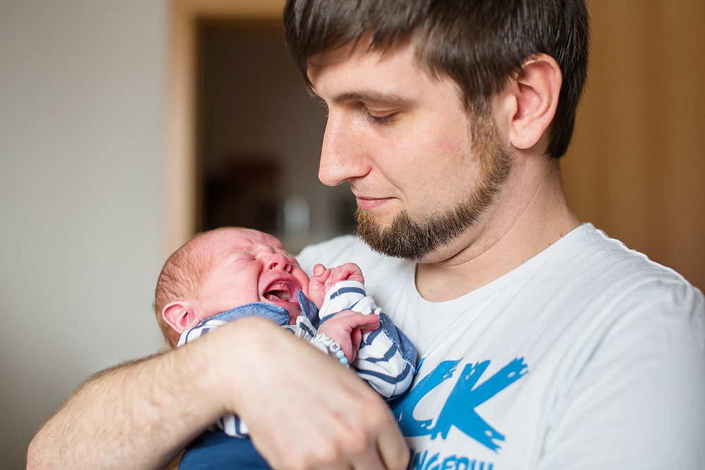 baby boy in daddys arms