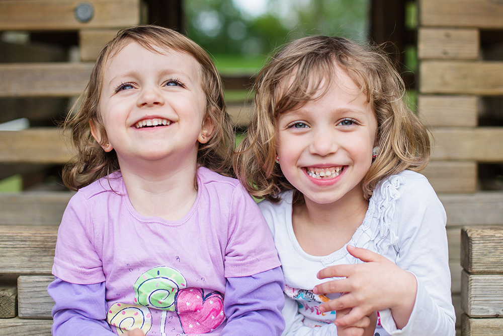 siblings sisters laughing together kids