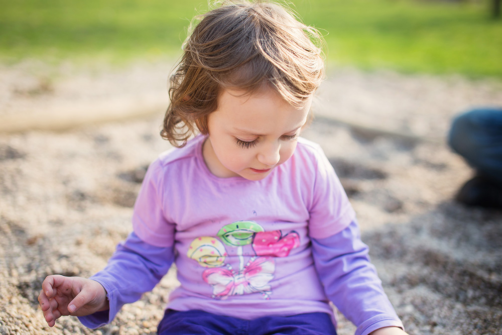 Lea on playground alone sandbox