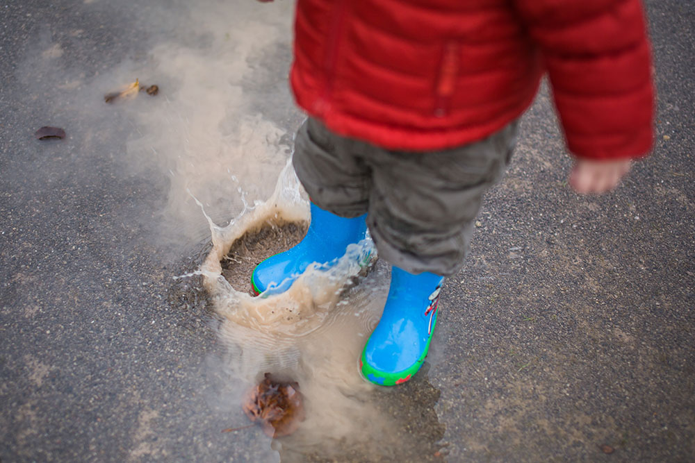 04 boy jumping in puddle