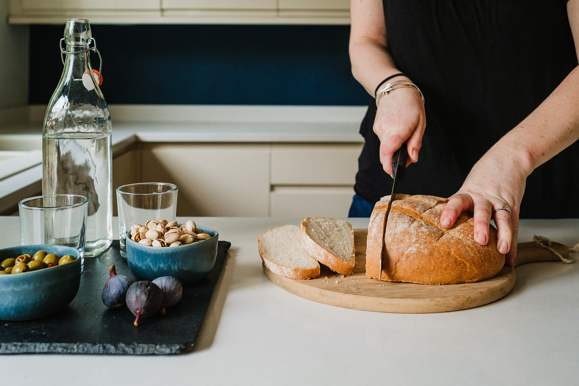 cutting bread in newly designed kitchen