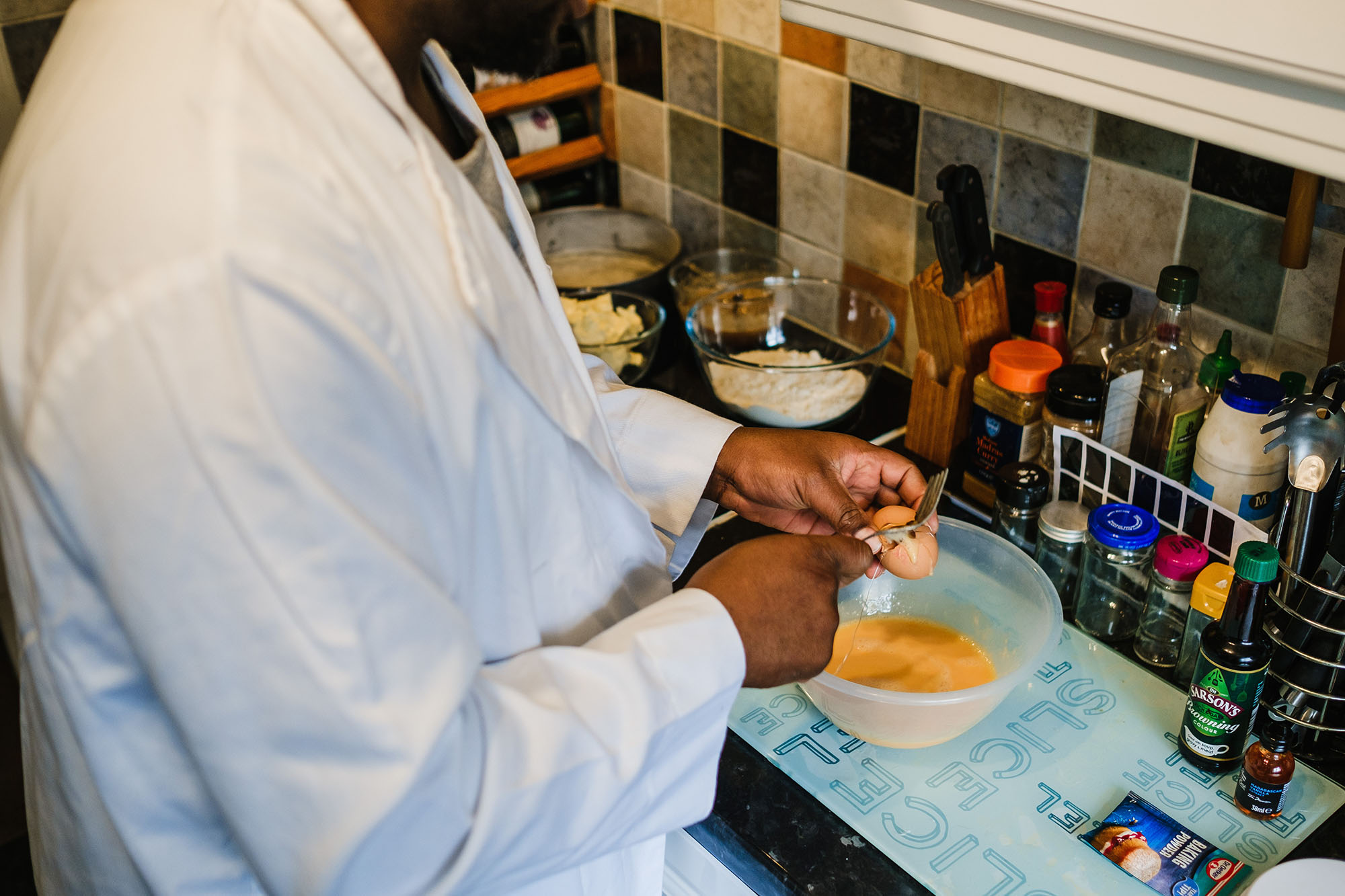 making rum cake cracking an egg