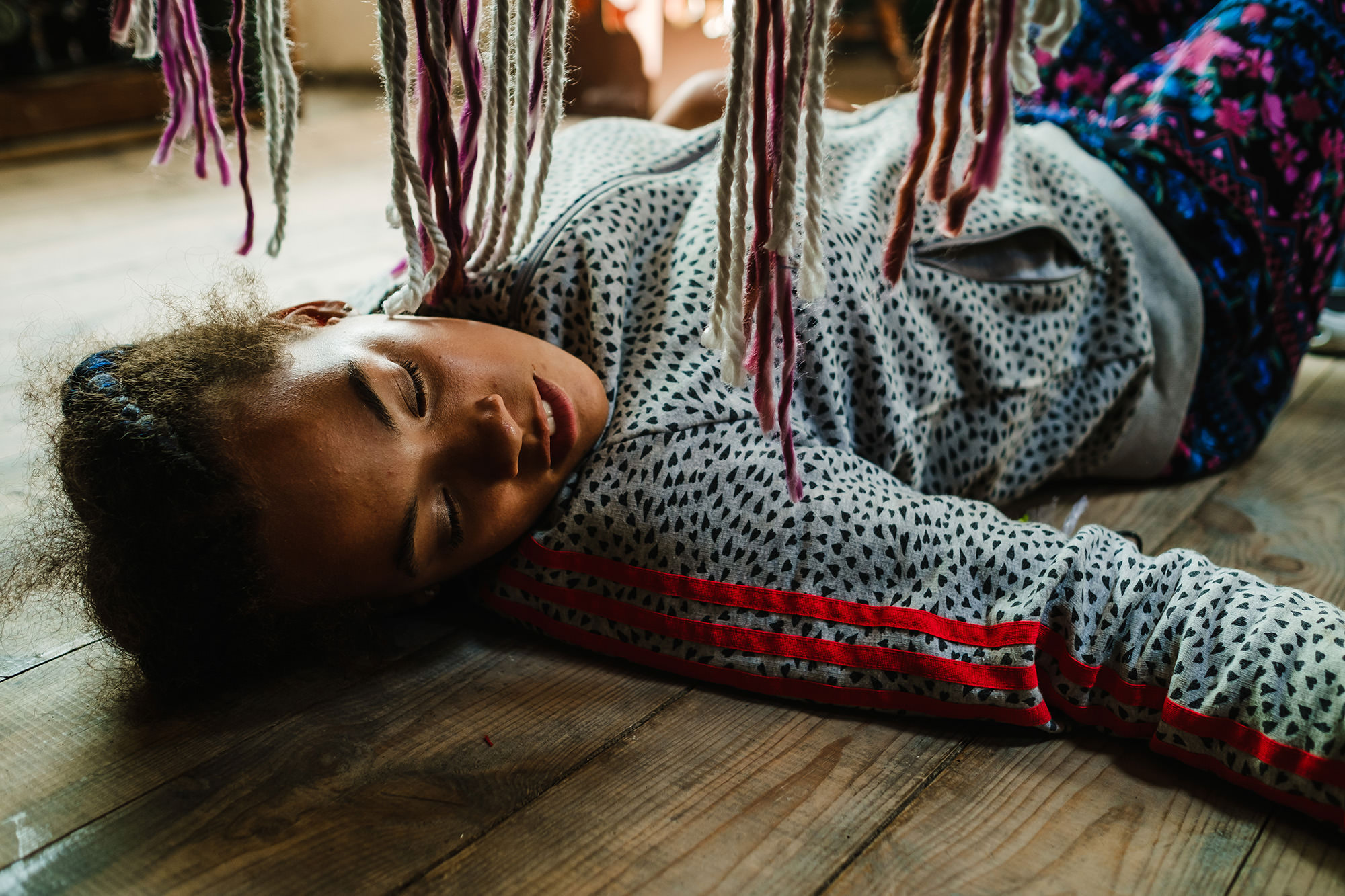 Halle on the floor with a hanging rug