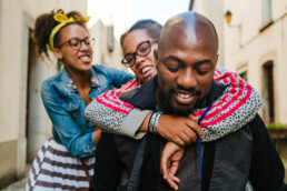 dad carrying daughters piggyback