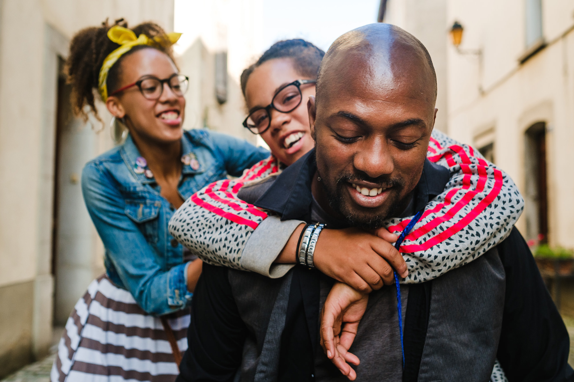 dad carrying daughters piggyback