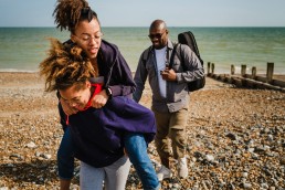 dad and daughters at the beach