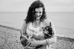 portrait of a woman with her dog on the beach