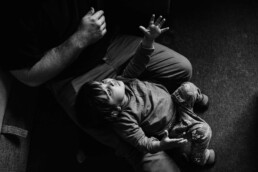 balck and white of toddler reaching for daddy